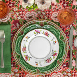 Cranberry and green place setting featuring Bordallo Pinheiro's Cabbage Green