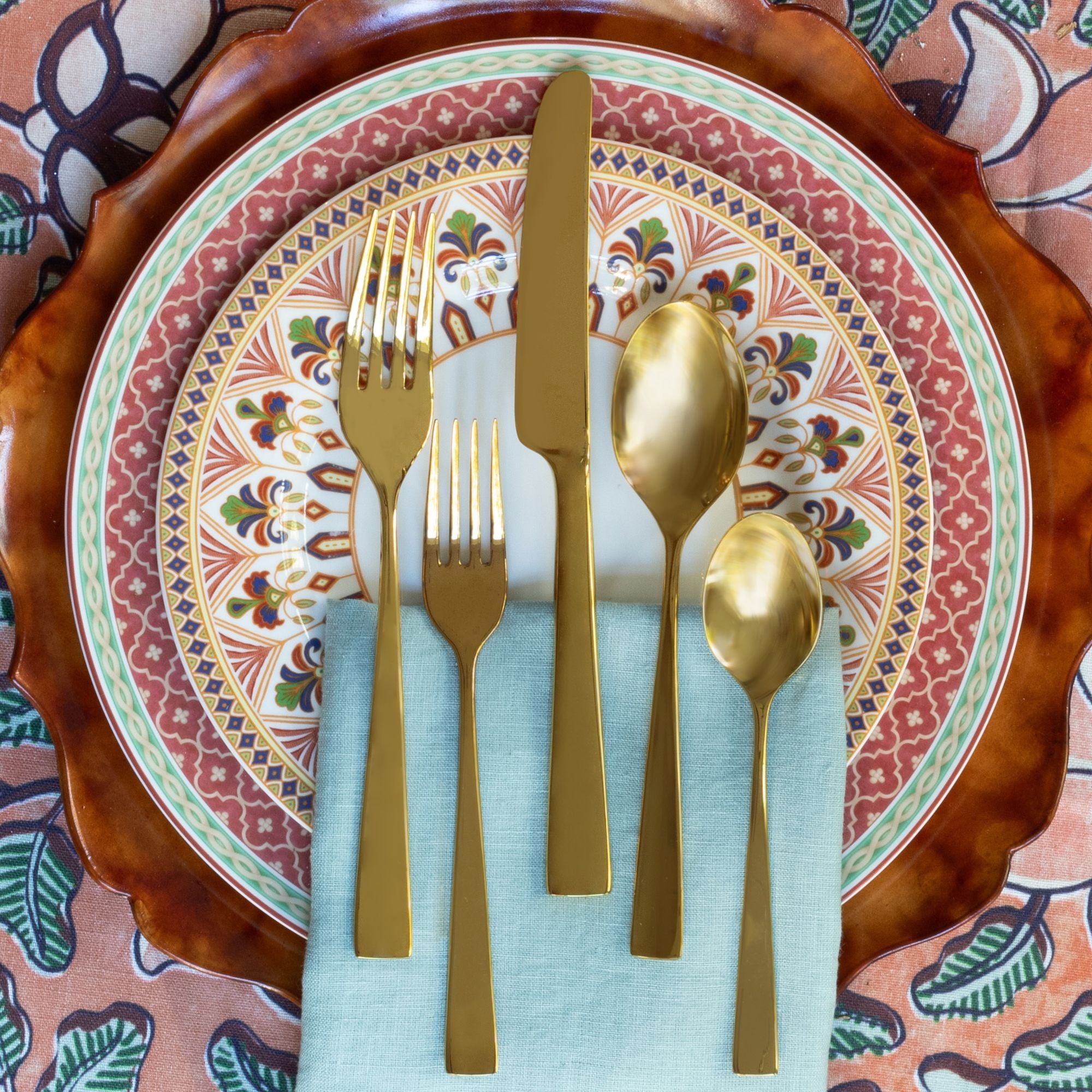 Earthtone place setting featuring gold flatware