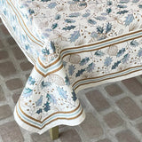 Decorative tablecloth with floral pattern on a brick floor