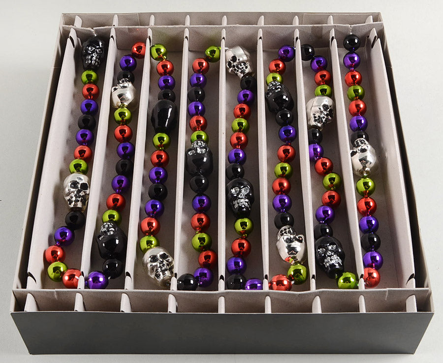 Colorful beaded bracelets with skull designs in a box