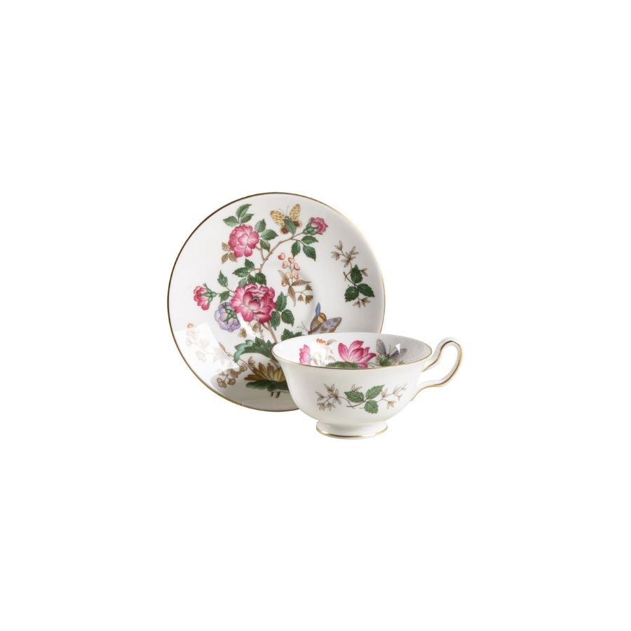 Teacup and saucer with floral design on a white background