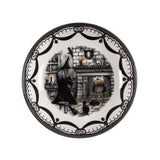 Decorative plate with a witch and cat design on a white background