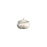Decorative silver sugar bowl with lid on a white background