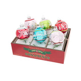 Box of Christmas tree ornaments with colorful designs on a white background
