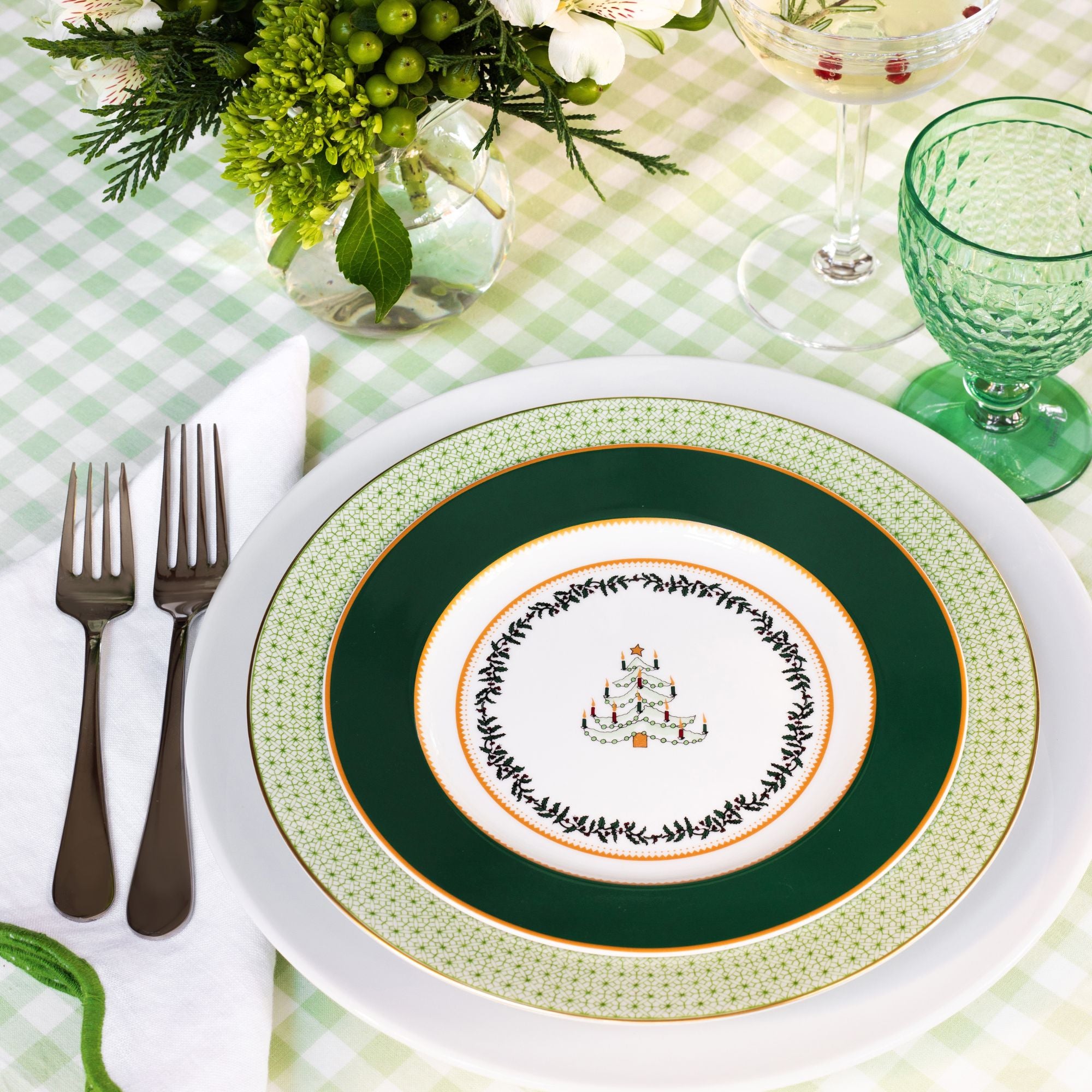 Holiday place setting featuring Grenadiers by Bernardaud, Green Apple Lace by Mottahedeh, and Boston Green by Villeroy & Boch.