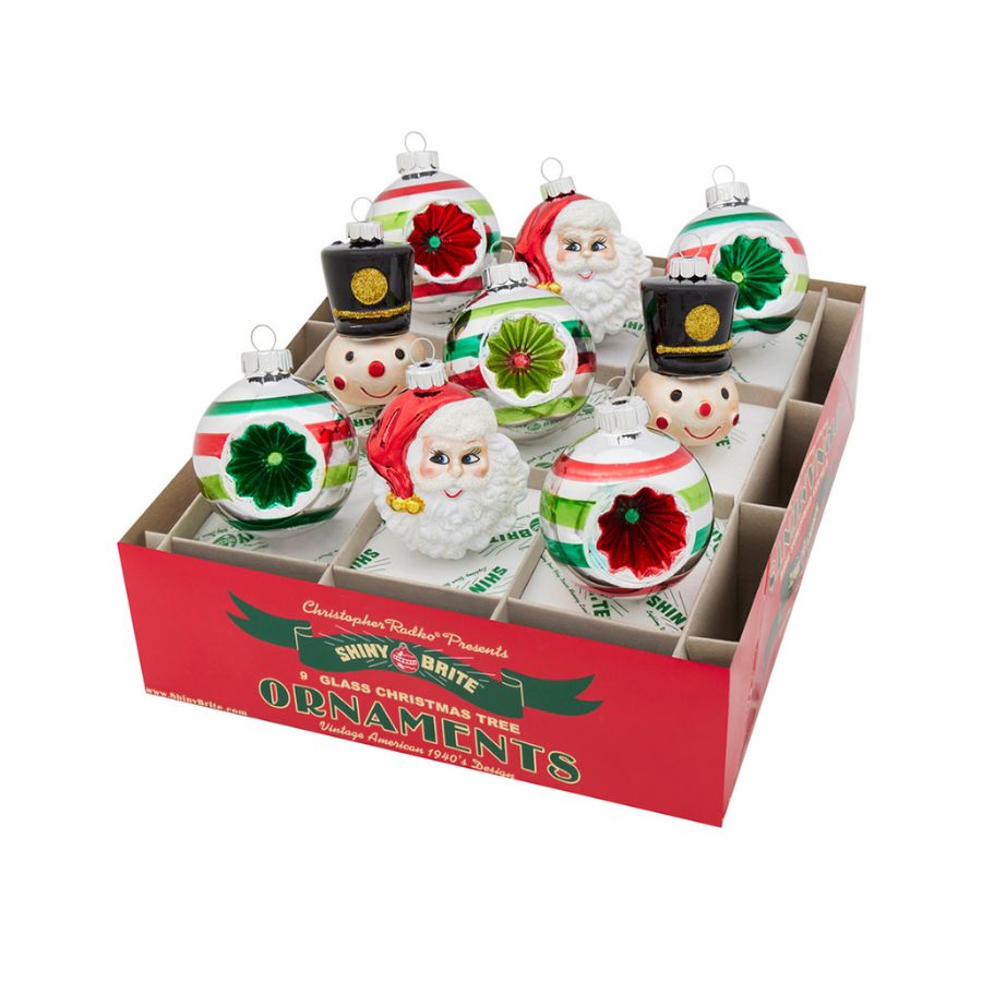 A box of Christmas ornaments  in various shapes in a box on a white background