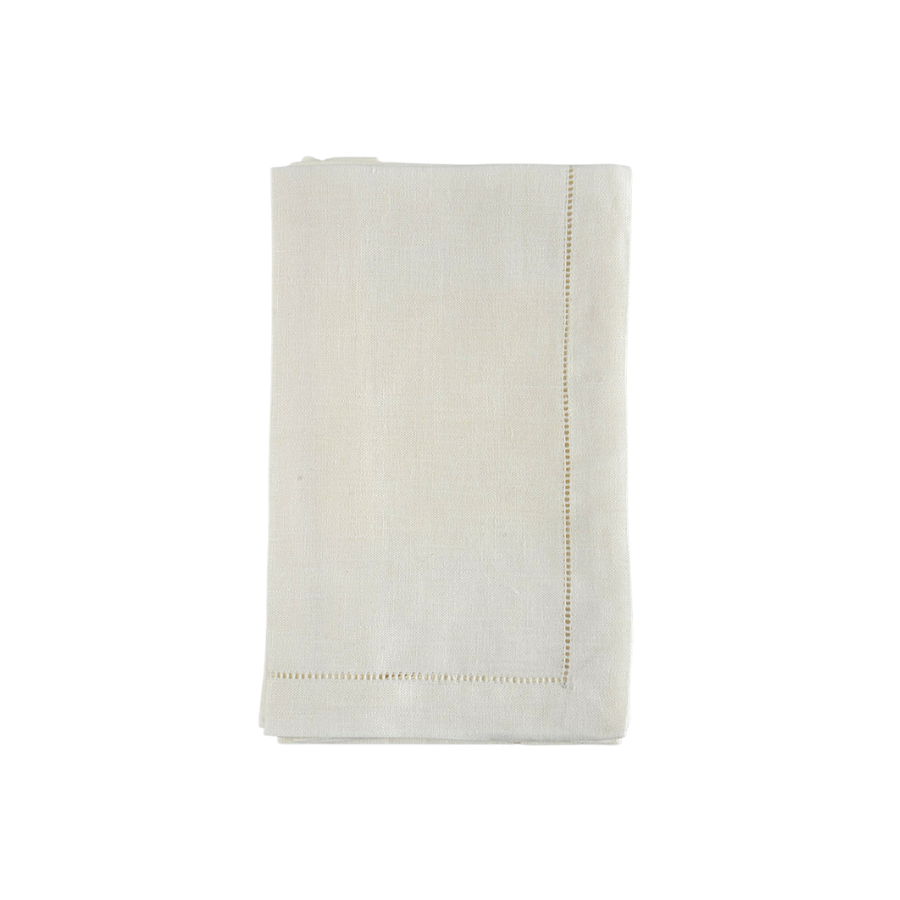 Warm white linen napkins with hemstitching folded on a white background.
