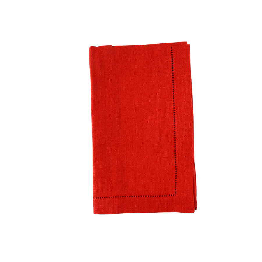 Folded red linen napkins with hemstitching on a white background.