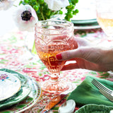 Shop Ivie Page Living - Trestle glassware in clear, pink, and green dresses up the table for any occasion.