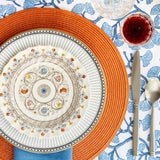 Florence collection place setting with a colorful oranges and blues used flowers and geometric patterns.