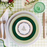 Lively green dinner plate topped with decorate salad plate feating a vintage Christmas tree and garland.