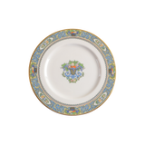 Decorative plate featuring urns of fruit and florals with a scroll border.