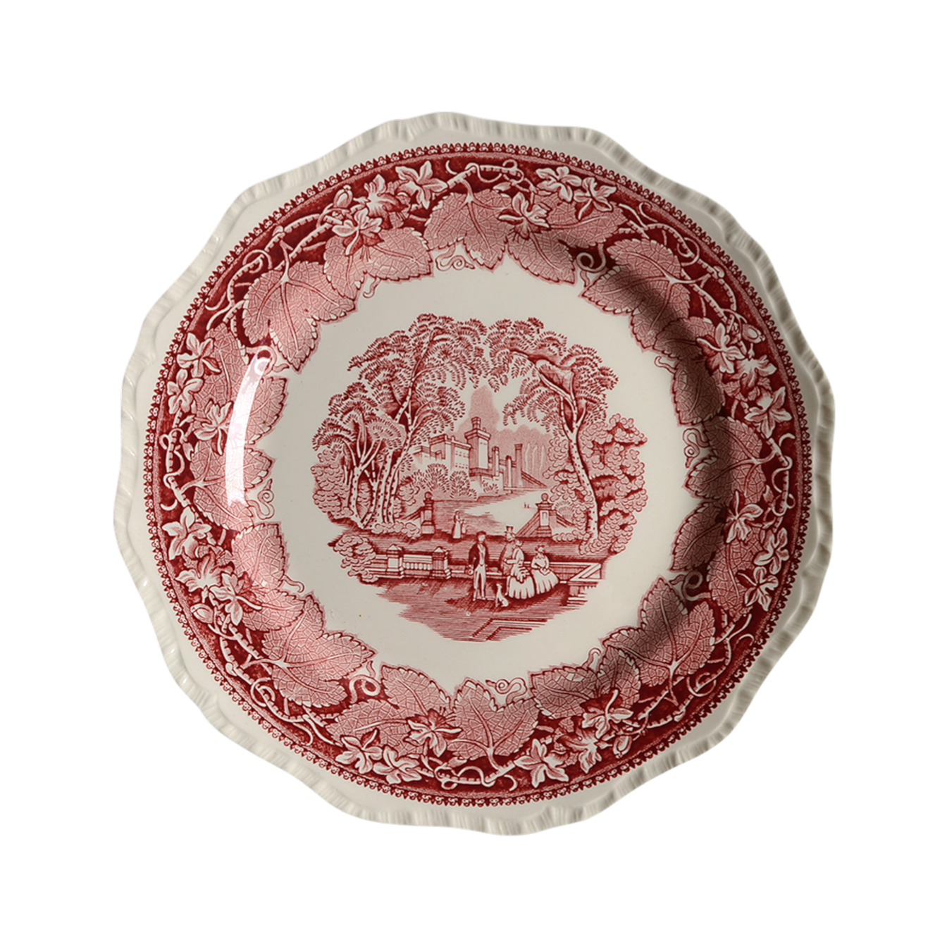 Decorative plate featuring a countryside scene in a leafy floral border.