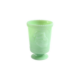 Jadeite glass footed tumbler featuring embossed Santa face.