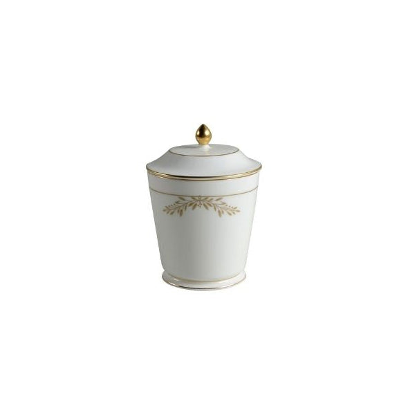 White ceramic jar with gold decorative elements on a white background
