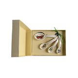 Set of decorative measuring spoons in a box with a butterfly design on a white background