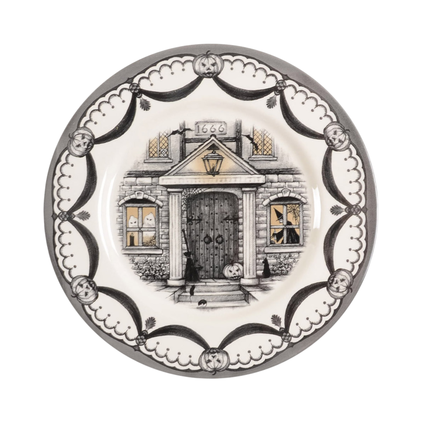 Decorative plate with a haunted house design on a white background