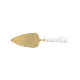 Gold cake server with white handle on a white background