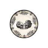 Decorative plate with skull design and floral patterns on a white background