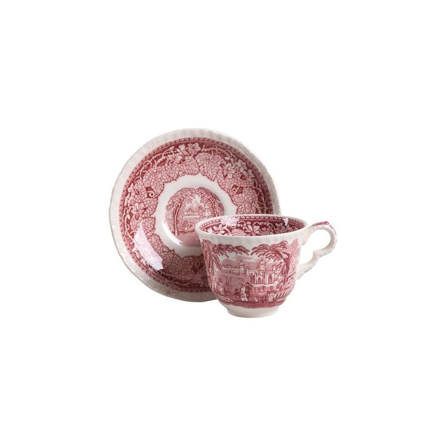 Red and white patterned cup and saucer on a white background
