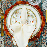 Oberon place setting topped by an elegant napkin and napkin ring