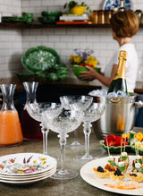 Stemware, Champagne, and appetizers arranged on a countertop.