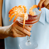 Shrimp cocktail served in elegant stemmed champagne glass.